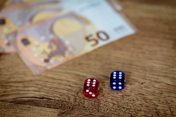 several colored dice and euro money