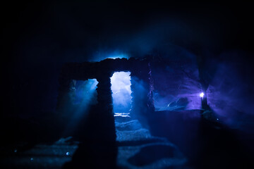 Old ruined stone house in deserted garden at night. Selective focus