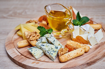 Cheese plate with honey, walnut, bread snacks