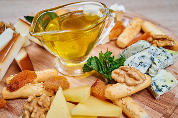 Cheese plate with honey, walnut, bread snacks