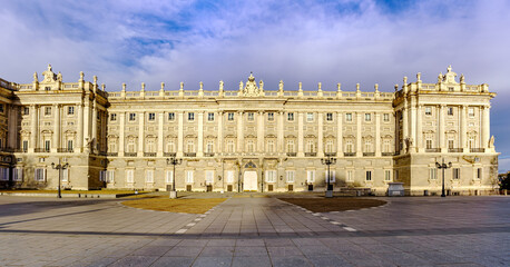 Fototapeta na wymiar Facade of the Royal Palace of Madrid at dawn, spectacular building residence of kings.
