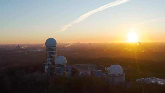 aerial view over abandoned surveillance station from cold war during sunrise