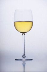 White wine in a glass on grey background