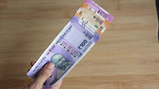Counting Indian currency Rupee , hand giving Indian money 100, 200, 2000 rupees banknote Kerala India 4K slow motion video, footage. Business woman counting giving money cash new Indian currency notes