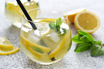Fototapeta premium Fresh summer drink. Cold lemonade with mint on a concrete background.