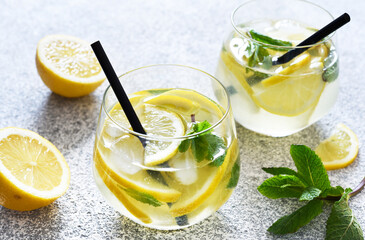 Fresh summer drink. Cold lemonade with mint on a concrete background.