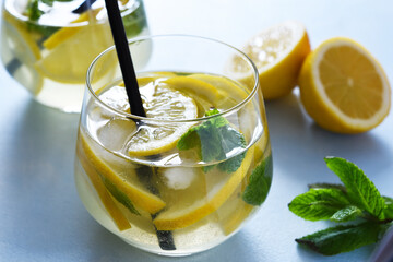 Fresh summer drink. Cold lemonade with mint on a concrete background.