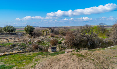 Fototapeta na wymiar Panoramic view of rural landscapes and ruins in the archaeological park of the ancient city of Troy near Canakkale, Turkey