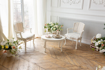 bedroom interior. white set of chairs and a table by the window