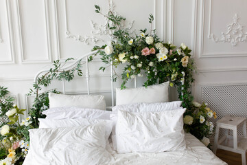 bedroom interior. white pillows on a large bed. the old bed is decorated with flowers