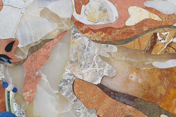 Natural abstract background. Fragment of a mosaic made of stone of different shades.