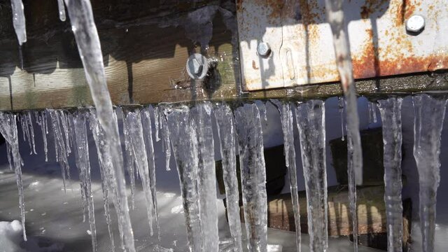Rusty bridge with ice Stalactites formatin