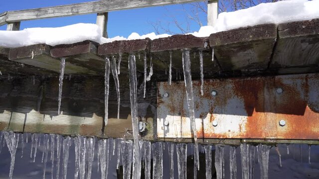 Rusty bridge with ice Stalactites formatin
