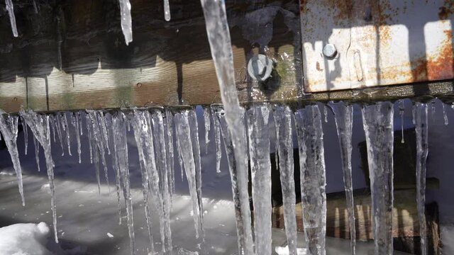 Rusty bridge with ice Stalactites formatin
