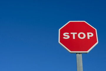 Stop traffic sign on blue background