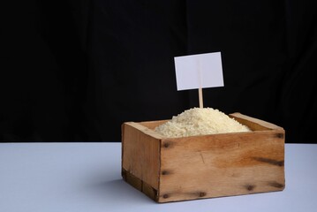 Brass inside a wooden box and a label for writing on it