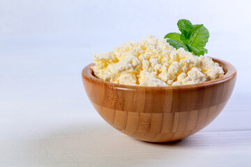 Homemade cottage cheese with a sprig of mint.
