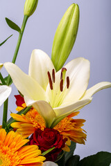 A beautiful bouquet of white lilies and orange gerberas