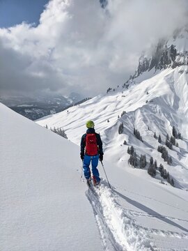 Freerider skiing mountain Silberen in powder snow. Ski tour in the Swiss mountains. Young man enjoys life. Skimo. View