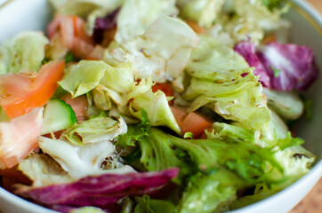 Green vegan salad from green leaves mix and vegetables.
