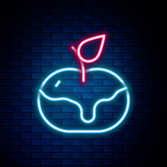 Glowing neon line Apple in caramel icon isolated on brick wall background. Colorful outline concept. Vector