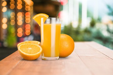 Orange juice in glass and slices of orange fruit