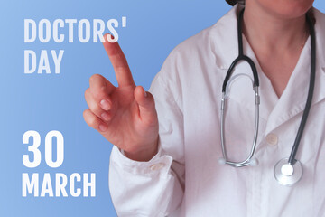 National Doctor's day. A young  Caucasian female doctor in a white coat on a blue background, points a finger at the inscription.
