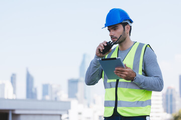 Smart engineer maintenance in solar power plant checking installing photovoltaic solar modules with digital tablet and using walkie talkie. Concept of sustainable resources, saving energy.