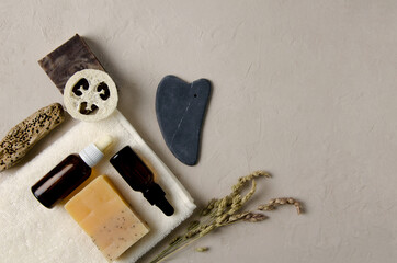 Cosmetic accessories for body, hand, face care. Natural soap, natural serum in glass bottles with a...