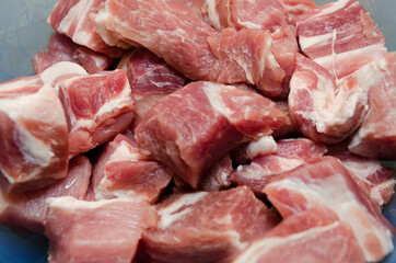 Raw pork, cut into small cubes in plates and ready to marinate. Close-up