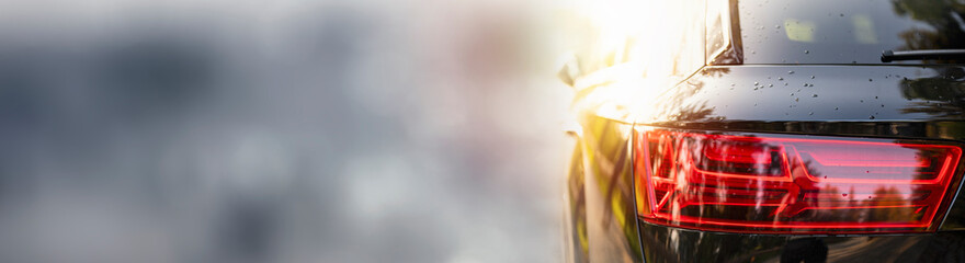 Modern silver car parking on the road. Close up. Headlights detail. Panorama, banner