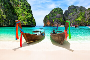 Beautiful beach with thai traditional wooden longtail boat and blue sky in Maya bay, Thailand.