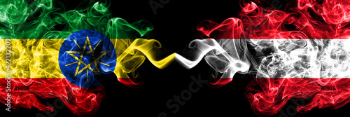 Ethiopia, Ethiopian vs Austria, Austrian smoky mystic flags placed side by side. Thick colored silky abstract smoke flags.