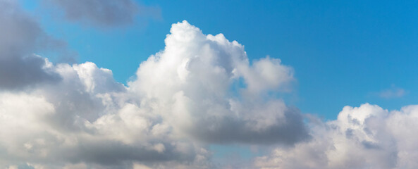 Naklejka na ściany i meble Big white curly cloud in the blue sky