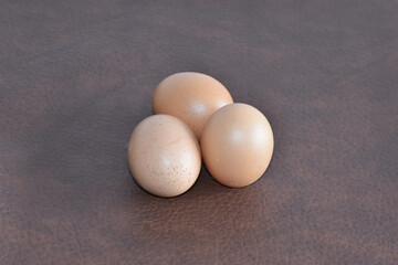 3 eggs with chicken left on the table, ready to cook breakfast, dinner, noon.