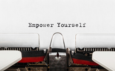 Text Empower Yourself typed on retro typewriter