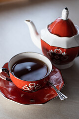 Black tea in beautiful old Langebraun red porcelain tea set called 