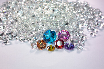 colorful diamonds are placed on a pile of white diamonds And keep turning. video 4k resolution shoot in studio.