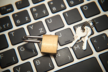 Computer security concept. Unlocked padlock on notebook keyboard. Symbol of safe. Selective focus
