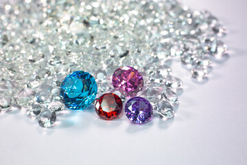 colorful diamonds are placed on a pile of white diamonds And keep turning. video 4k resolution shoot in studio.