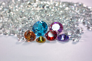 colorful diamonds are placed on a pile of white diamonds And keep turning. video 4k resolution shoot in studio.