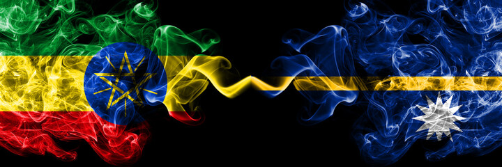 Ethiopia, Ethiopian vs Nauru, Nauruan smoky mystic flags placed side by side. Thick colored silky abstract smoke flags.