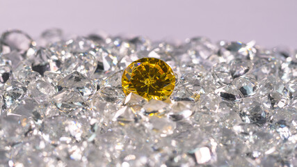 Yellow diamonds are placed on a pile of white diamonds And keep turning. video 4k resolution shoot in studio.