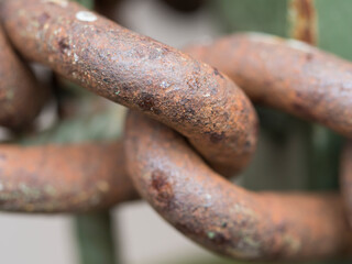 Macro of old rusty thick iron chain link, selective focus. connection or joinning concept