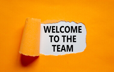 Welcome to the team symbol. Words 'Welcome to the team' appearing behind torn orange paper. Beautiful orange background. Business, welcome to the team concept, copy space. © Dzmitry