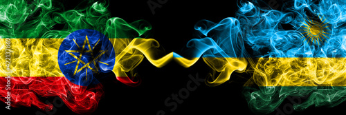 Ethiopia, Ethiopian vs Rwanda smoky mystic flags placed side by side. Thick colored silky abstract smoke flags.