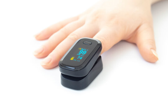 Portable black pulse oximeter on a white background. Monitoring the oxygen level at home. Covid-19, a heart rate health tester is used to measure the air in the lungs.