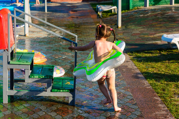 Children's entertainment in the pool, a fun descent from the slide into the pool with water.