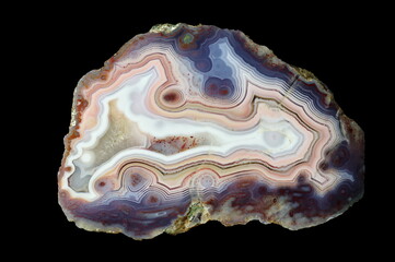 A cross section of the agate stone. Eyelet agate. Multicolored silica bands colored with metal oxides are visible. Origin: Rudno near Krakow, Poland.