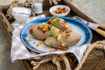 Traditional Lithuanian dish Zeppelin, boiled potato dumplings stuffed with minced pork, on a...